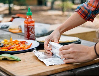 camp cooking - rolling a breakfast burrito